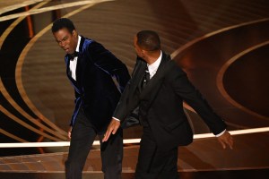 TOPSHOT - US actor Will Smith (R) slaps US actor Chris Rock onstage during the 94th Oscars at the Dolby Theatre in Hollywood, California on March 27, 2022. (Photo by Robyn Beck / AFP) (Photo by ROBYN BECK/AFP via Getty Images)